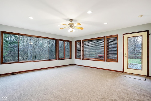 carpeted empty room featuring ceiling fan