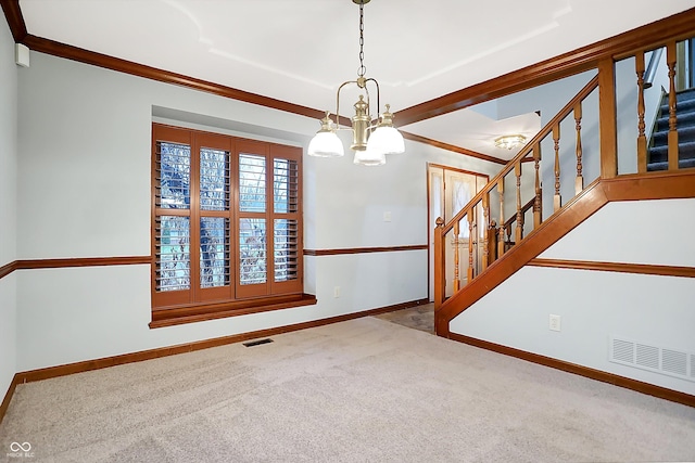 carpeted empty room with crown molding and a chandelier