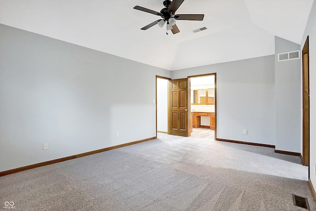 unfurnished bedroom featuring light carpet, connected bathroom, ceiling fan, and lofted ceiling