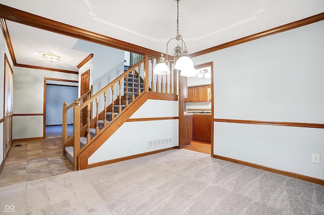 staircase with a notable chandelier, ornamental molding, and carpet floors