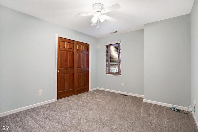 unfurnished bedroom with carpet floors, a closet, and ceiling fan