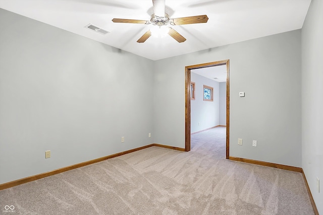 carpeted empty room featuring ceiling fan