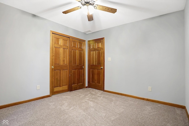 unfurnished bedroom featuring carpet flooring, ceiling fan, and a closet