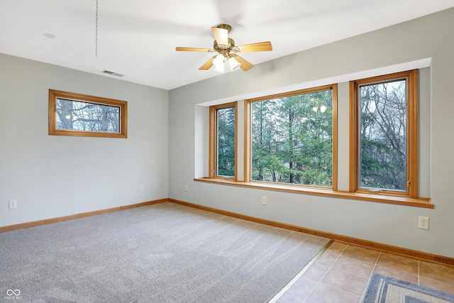 tiled empty room with ceiling fan