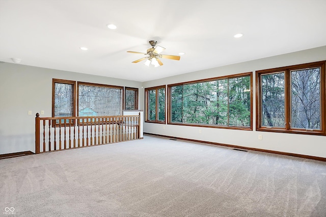 carpeted empty room featuring ceiling fan