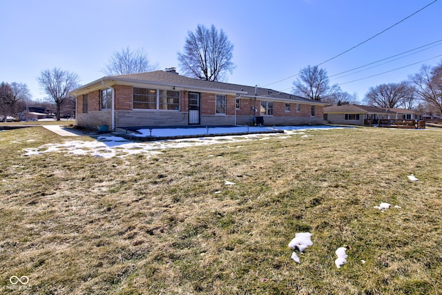 rear view of property featuring a lawn