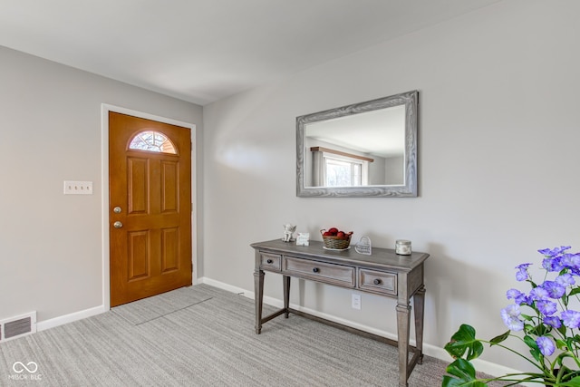 entrance foyer featuring light carpet