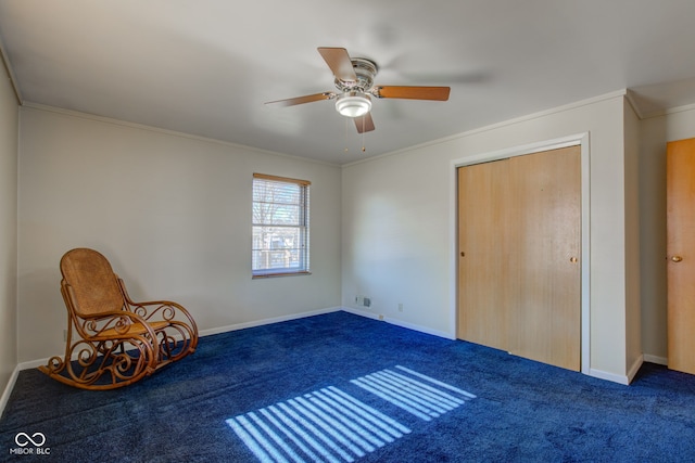 interior space featuring ceiling fan, ornamental molding, and carpet flooring