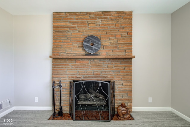 interior details with a large fireplace and carpet floors