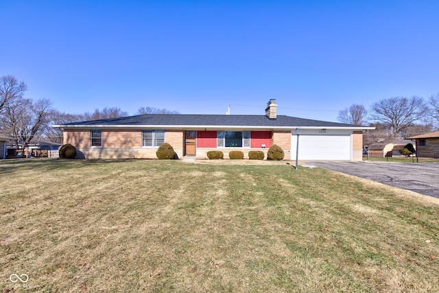 single story home featuring a garage and a front lawn