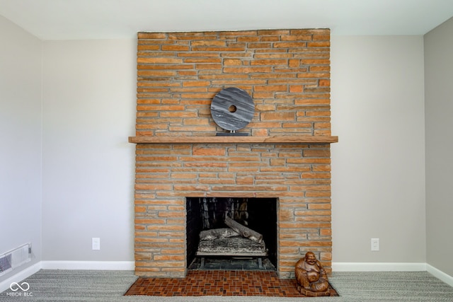 details featuring a fireplace and carpet floors