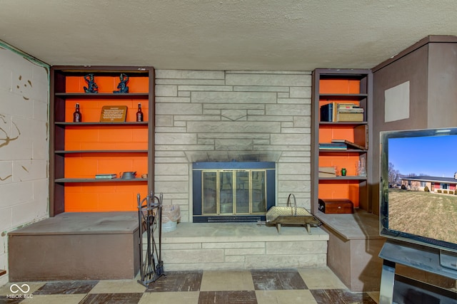 living room featuring a fireplace and a textured ceiling