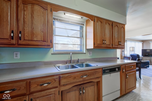 kitchen featuring white dishwasher and sink