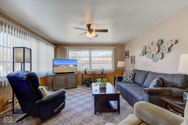 carpeted living room featuring ceiling fan