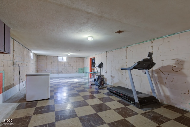 workout area featuring a textured ceiling