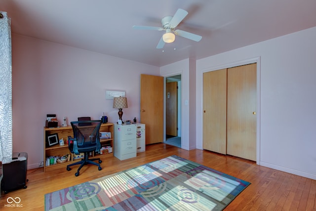 office with wood-type flooring and ceiling fan