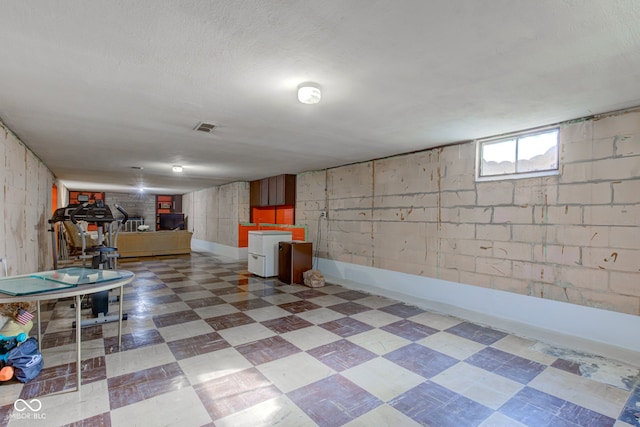 basement featuring a textured ceiling