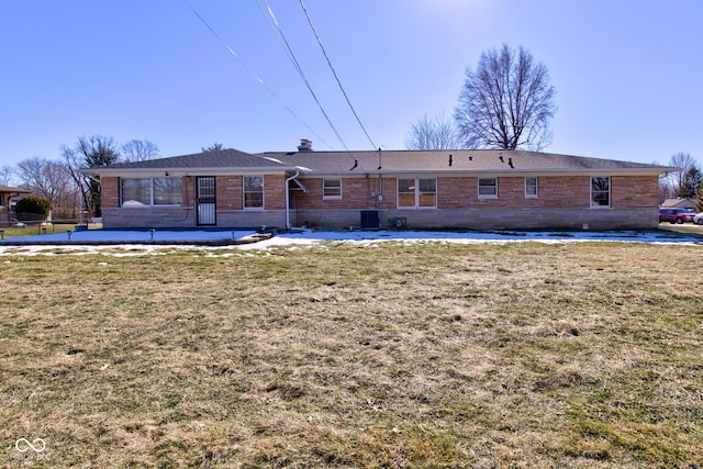 back of property featuring a yard and central AC unit