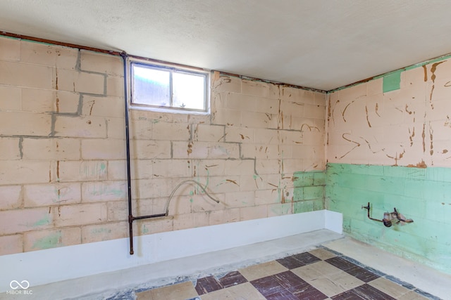 basement featuring a textured ceiling