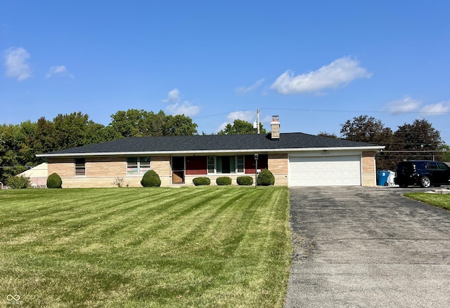 single story home with a garage and a front lawn