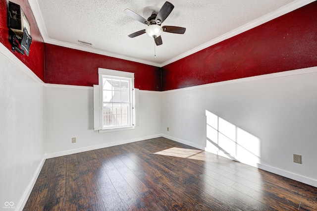 spare room with a textured ceiling, ceiling fan, dark hardwood / wood-style flooring, and crown molding