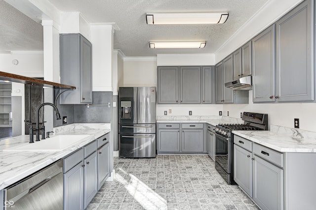 kitchen featuring a textured ceiling, appliances with stainless steel finishes, gray cabinetry, and sink