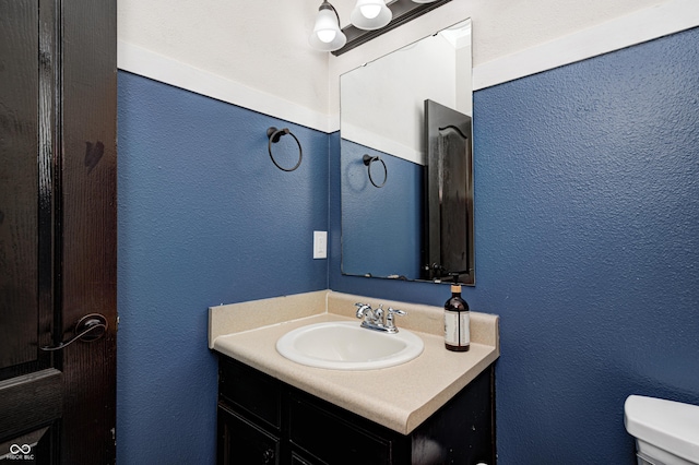 bathroom with toilet and vanity