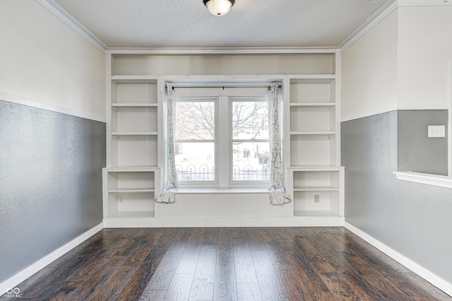 spare room featuring dark hardwood / wood-style floors and a textured ceiling