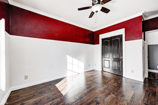 unfurnished room featuring ceiling fan, dark wood-type flooring, and ornamental molding