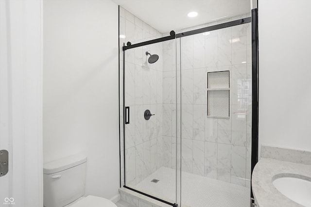 bathroom with toilet, an enclosed shower, and sink