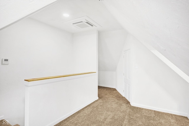 bonus room with light carpet and lofted ceiling