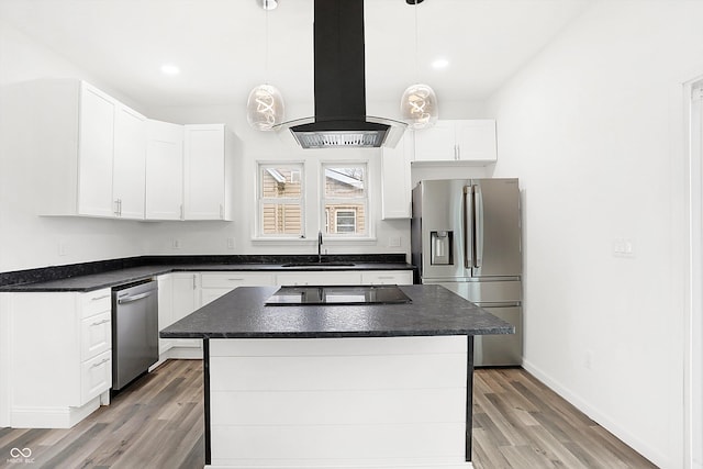 kitchen featuring white cabinetry, stainless steel appliances, decorative light fixtures, island range hood, and a kitchen island