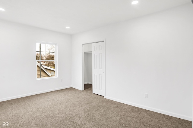 unfurnished bedroom with carpet and a closet