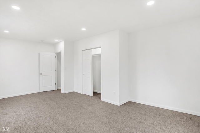 unfurnished bedroom with carpet floors and a closet