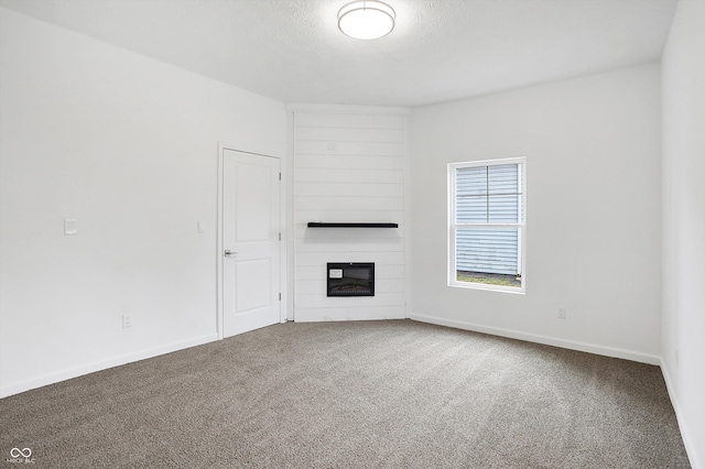 unfurnished living room featuring a fireplace and carpet