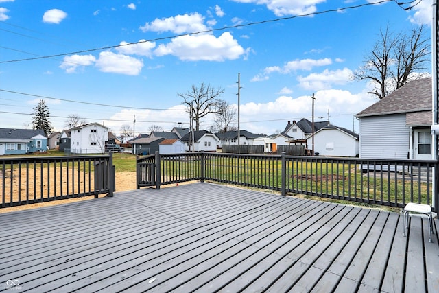 wooden terrace featuring a yard