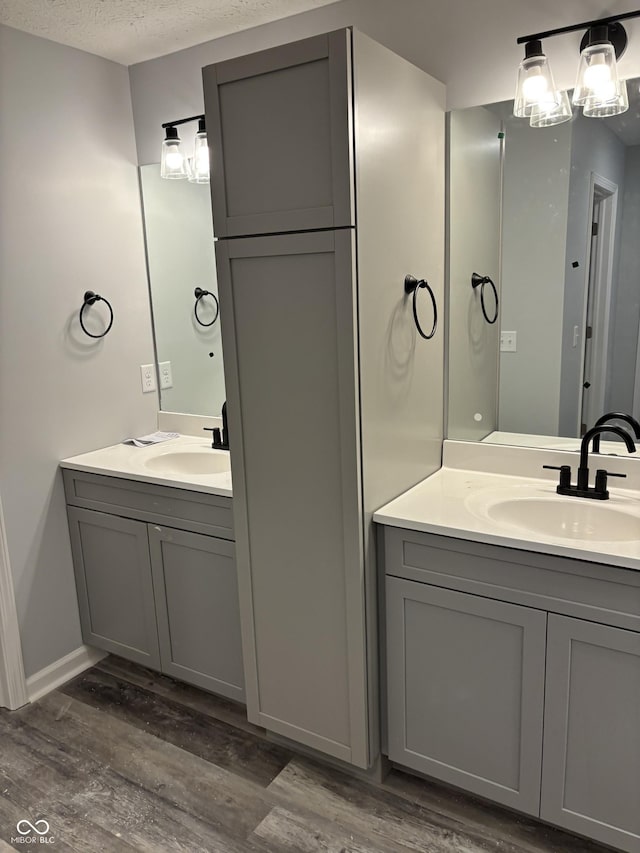 1433 Wigwam Ln, Martinsville, IN 46151 - bathroom with vanity, wood finished floors, a textured ceiling, and baseboards