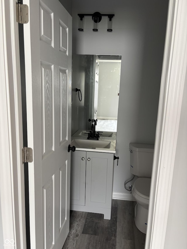 1433 Wigwam Ln, Martinsville, IN 46151 - half bath featuring vanity, toilet, wood finished floors, and baseboards