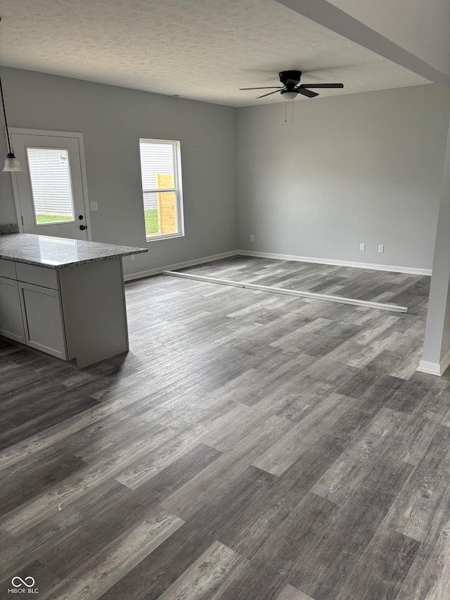 1433 Wigwam Ln, Martinsville, IN 46151 - unfurnished living room with dark wood finished floors, ceiling fan, baseboards, and a textured ceiling