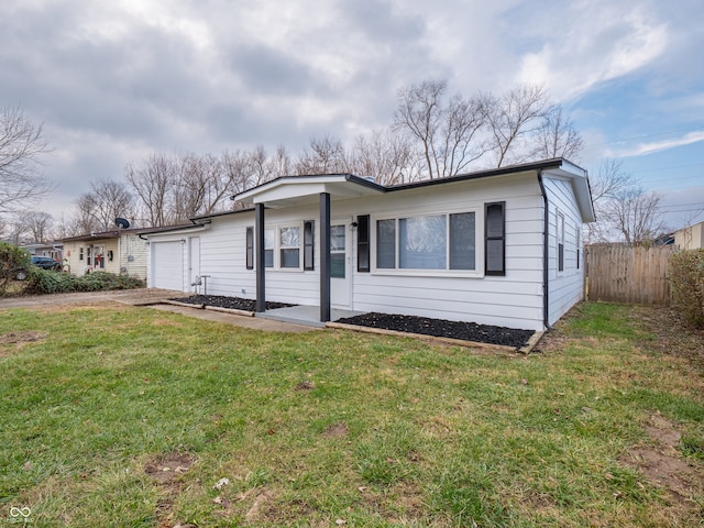 single story home with a garage and a front yard