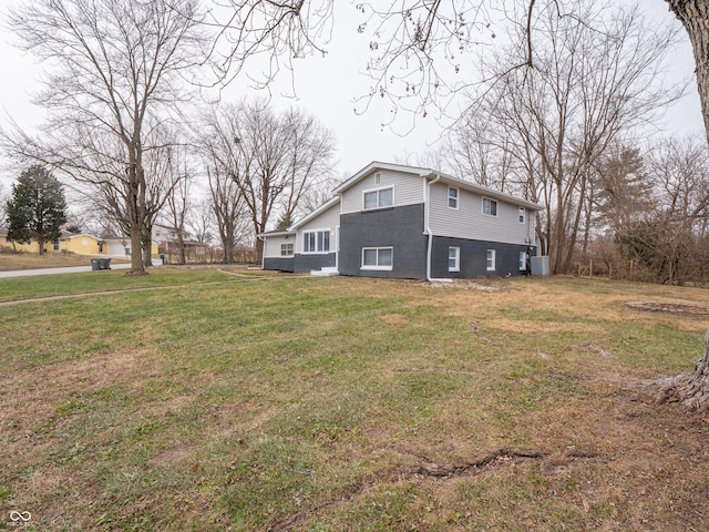 view of side of home with a lawn