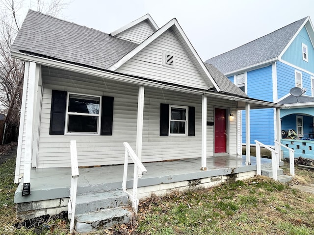 2134 Pleasant St, Indianapolis, IN 46203 - view of front of house featuring covered porch and a shingled roof