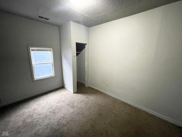 unfurnished bedroom featuring carpet and a textured ceiling