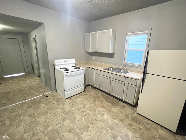 kitchen featuring a textured ceiling, white appliances, white cabinetry, and sink