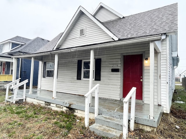 2134 Pleasant St, Indianapolis, IN 46203 - view of front facade featuring a shingled roof and a porch
