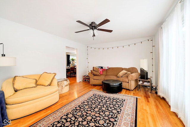 living room with ceiling fan and hardwood / wood-style flooring