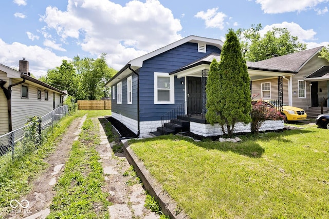 bungalow-style house featuring a front yard