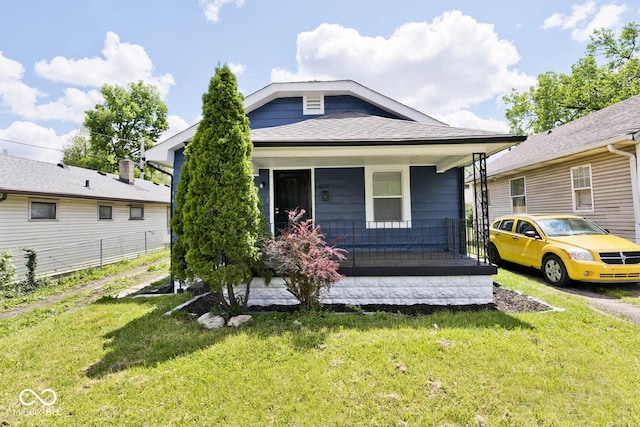 bungalow-style home with a front lawn and covered porch