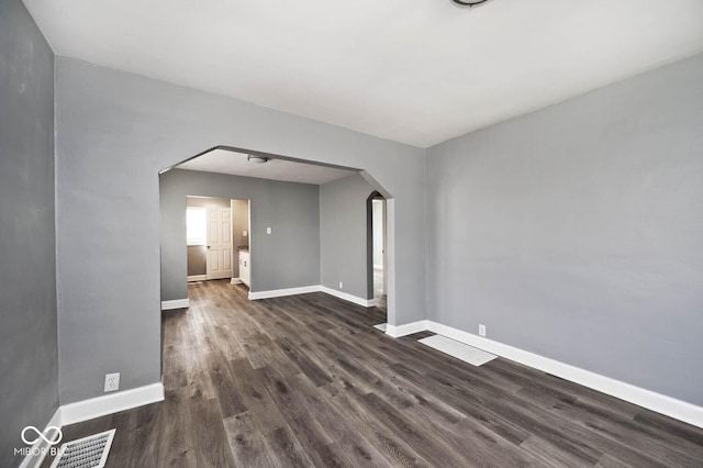 empty room featuring dark wood-type flooring