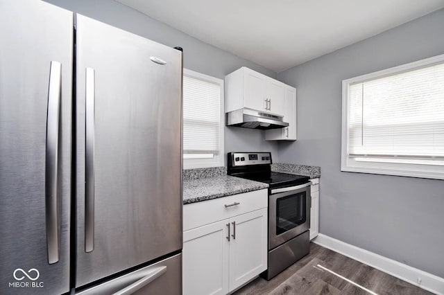 kitchen featuring light stone countertops, appliances with stainless steel finishes, dark hardwood / wood-style flooring, and white cabinetry